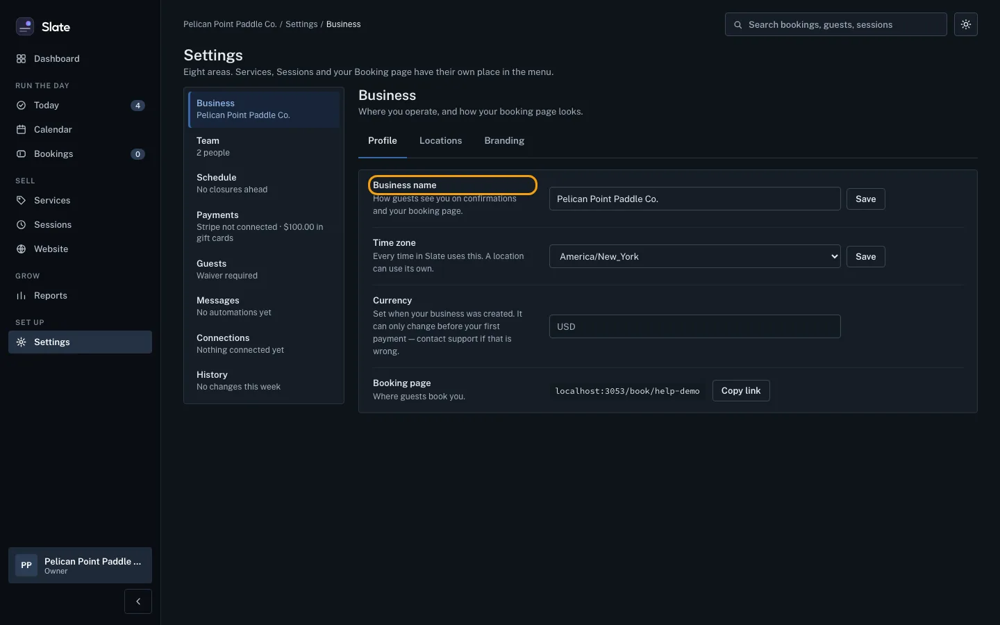 The Profile tab of Business settings, with the Business name row outlined, and rows for Time zone, Currency and Booking page below.