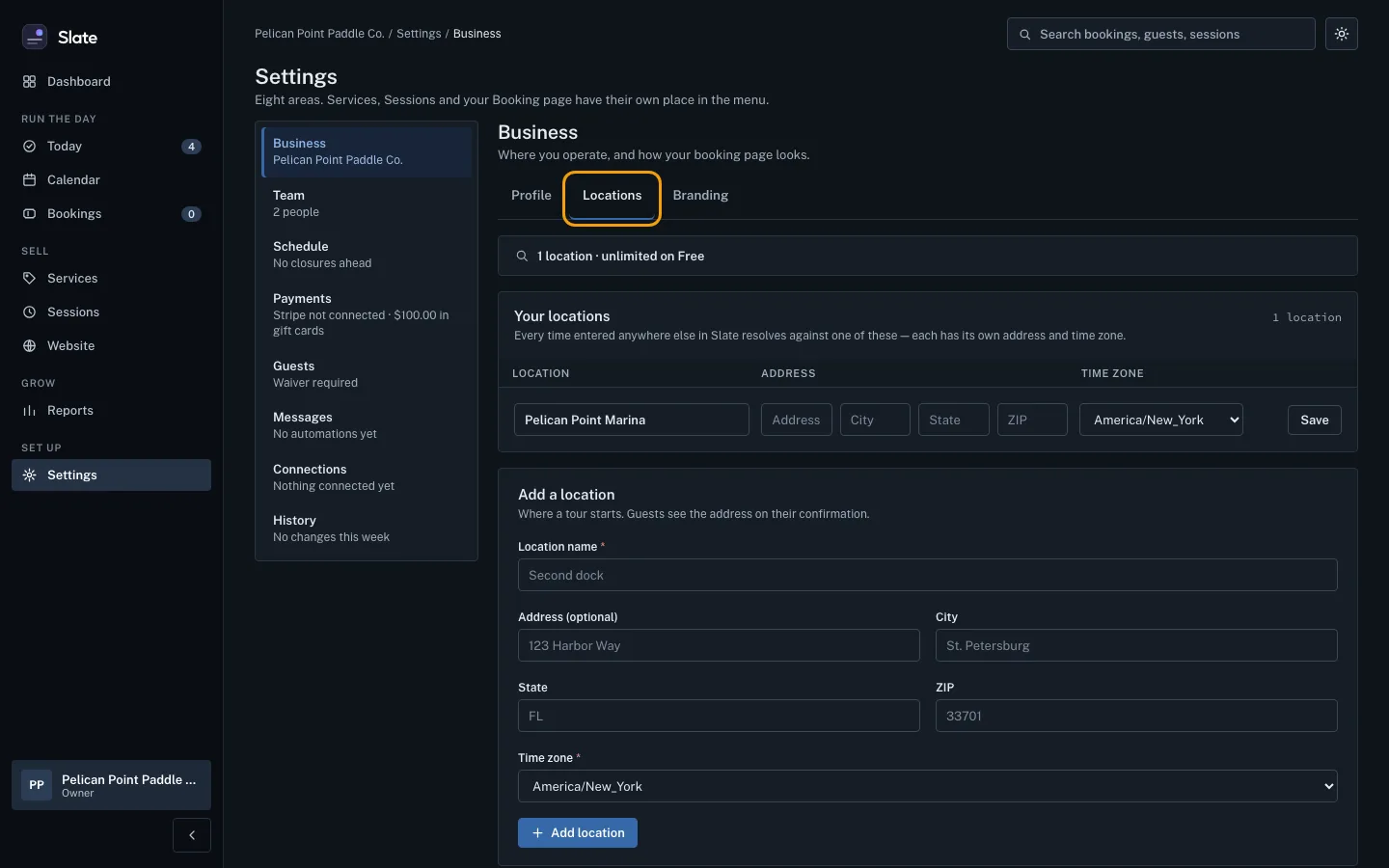 The Locations tab under Business settings, outlined, listing one location, Pelican Point Marina, in the America/New_York time zone.